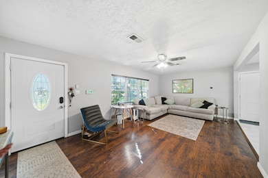 Front entry into the living area featuring wood flooring and plenty of natural light!