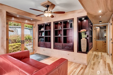Living room has french doors that open to the backyard amenities.