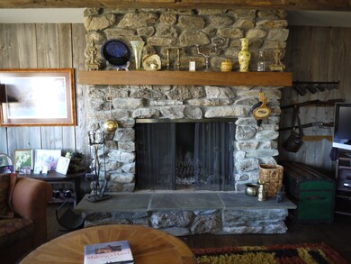 fieldstone fireplace in living room