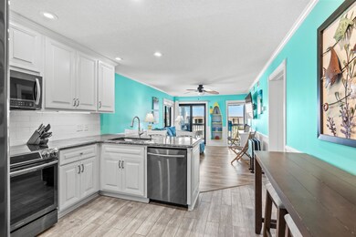 Kitchen featuring white cabinetry, sink, light woo