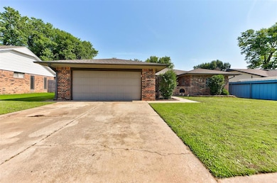 View of front of property with brick siding and a garage