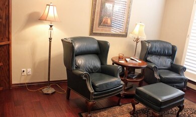Den/Study has wide plank wood floors, built ins & 