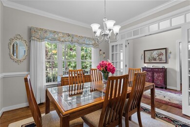 Dining Room with crown molding, a chandelier, and
