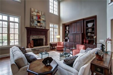 Perfectly located in the center of the home with easy access to kitchen, deck, and luxury wet bar/butlers pantry.  Relax and enjoy the stone fireplace with gas starter and custom built wood cabinetry. 