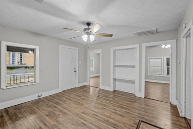 Entrance foyer featuring a ceiling fan, wood finis