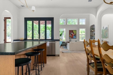 Kitchen featuring dishwasher, dark countertops, a