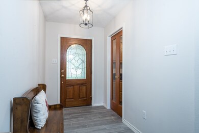 Welcome into the entry with leaded glass front door.