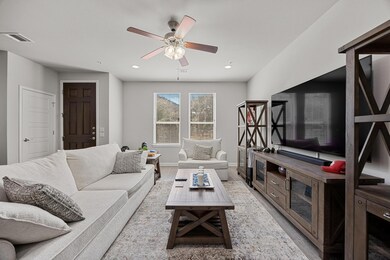 Living room with baseboards, visible vents, a cei