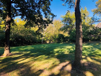 Many types of mature trees surround the lot.