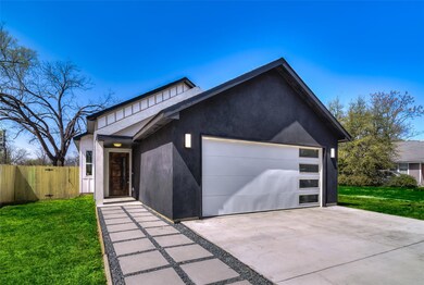 Contemporary home with driveway, a front yard, stu