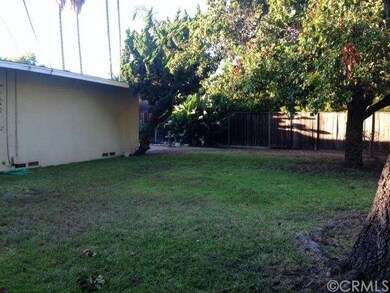 backyard with large grassy area.