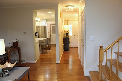 View of kitchen and front foyer from living room.