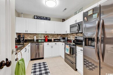 Kitchen featuring light tile patterned flooring, w