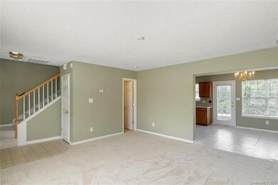 LIVING ROOM: The foyer opens to a spacious living 