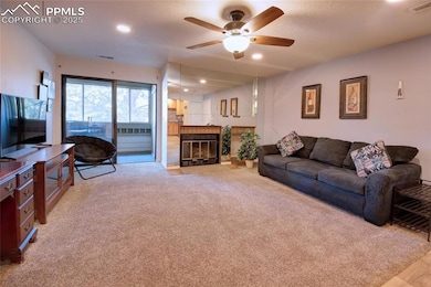Living room with fireplace and glass doors to the balcony