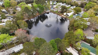 Birds eye view of property with a water view and a