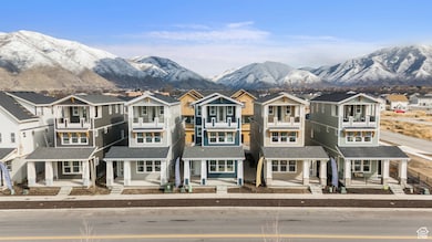 View of front of property featuring a residential view, a mountain view, and covered porch
