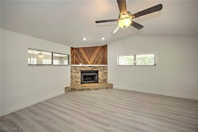 Unfurnished living room featuring vaulted ceiling,