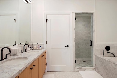 Spa-like bathroom with soaking tub, dual vanities,