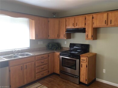The kitchen has beautiful wood cabinets, granite countertops, and stainless appliances.