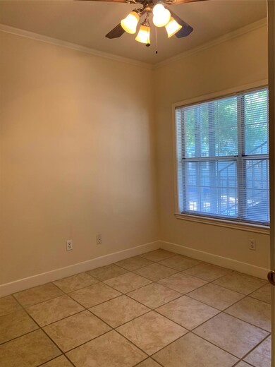Unfurnished room featuring baseboards, light tile