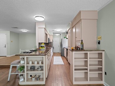 View of spacious kitchen leading to flex room , an
