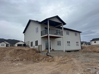 Rear view of house with a patio and stucco siding