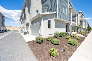 View of home's exterior featuring an attached garage, driveway, stucco siding, and a residential view