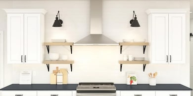 Kitchen with stainless steel hood and full backsplash