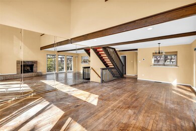 Unfurnished living room featuring beamed ceiling, 