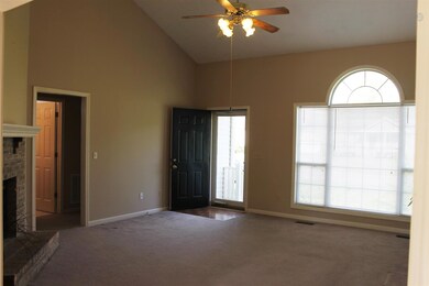 Vaulted celings, gas fireplace, ceiling fan and abundant natural light ! Storm Door at entry door.