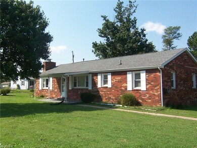 This solid brick ranch is located on a double, cor