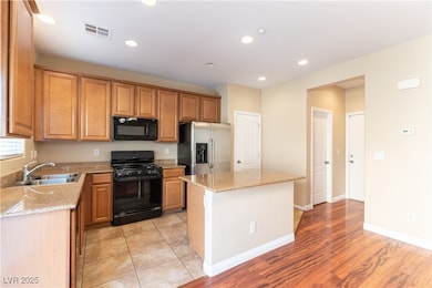 Kitchen featuring black appliances, a sink, a cent