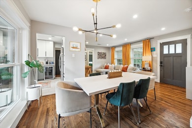 The dining area, situated by a large window, is ne