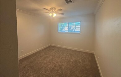 Carpeted spare room featuring ornamental molding 