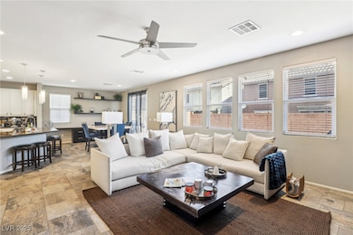 Living room with light stone finish floors, a ceil