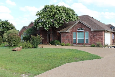 Ranch-style home featuring brick siding, a shingl