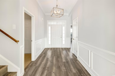 Entrance foyer featuring an inviting chandelier, c