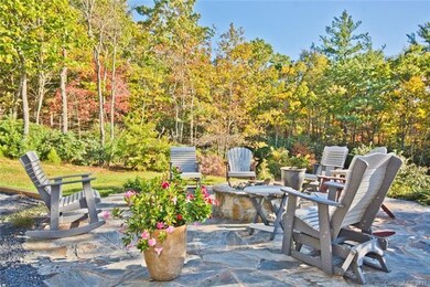 Relax at Stone Firepit Next to Wisteria Vine Pergo