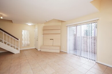 Bright and open living area with tile flooring, a