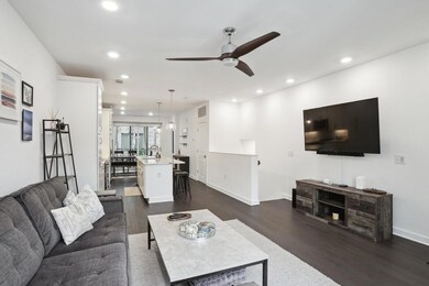 Living area with dark wood-style floors, ceiling fan, recessed lighting, and baseboards