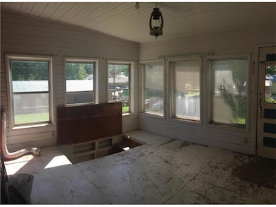 Sunroom with entry to basement.