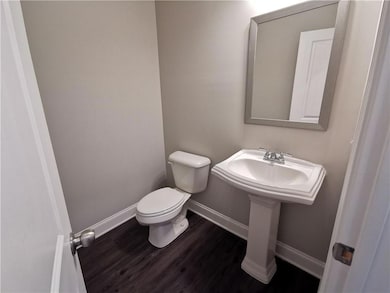 Bathroom featuring toilet and wood finished floors