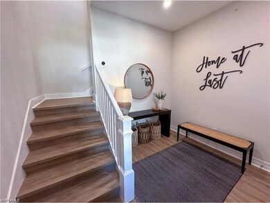 Staircase featuring wood finished floors and baseb