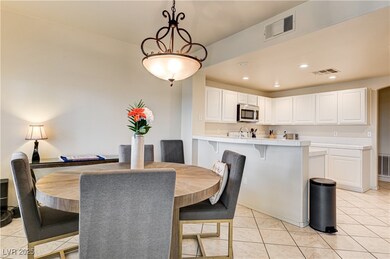 Dining space featuring light tile patterned floors and recessed lighting