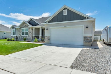 Craftsman inspired home with stone siding, board and batten siding, driveway, and an attached garage