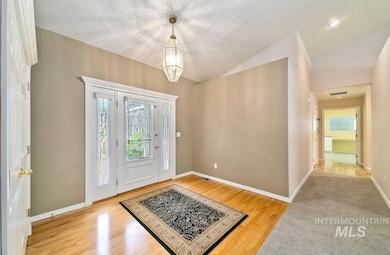 Entrance foyer featuring lofted ceiling and wood finished floors