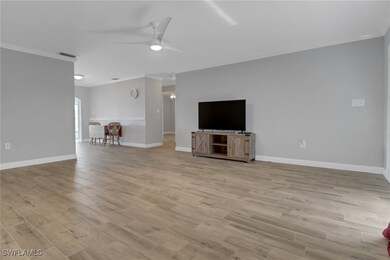 Unfurnished living room with ceiling fan, ornament