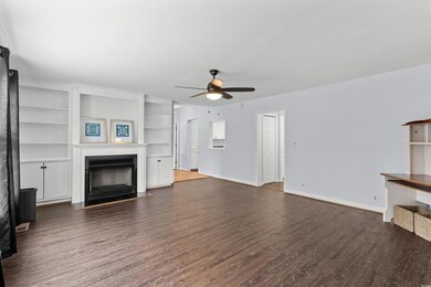 Unfurnished living room featuring built in shelves