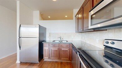 Kitchen featuring dark wood-style flooring, brown